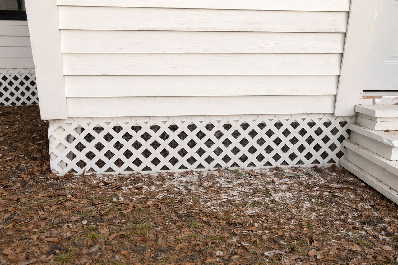Lattice skirting fitted along the base of a home