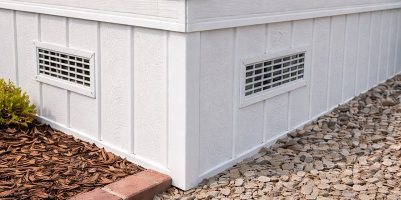 Finished white vinyl mobile home skirting with built-in ventilation grilles